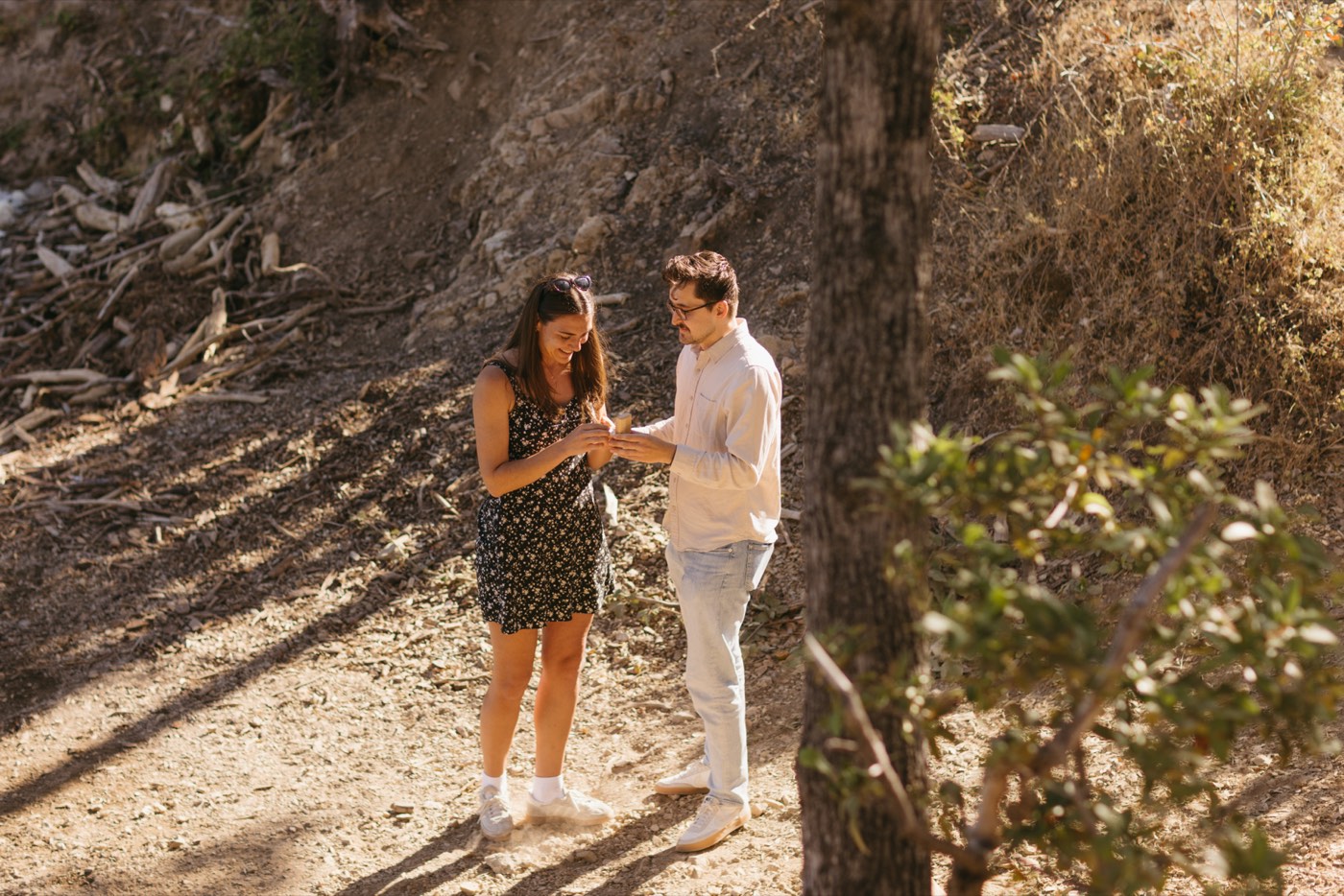 Alex placing the ring on Andrea's finger